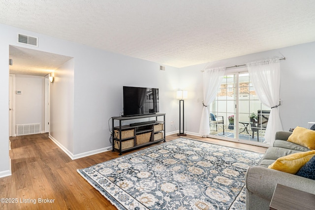 1251 Westlynne Way Apt 2, Louisville, KY 40222 - living room featuring wood finished floors and a textured ceiling