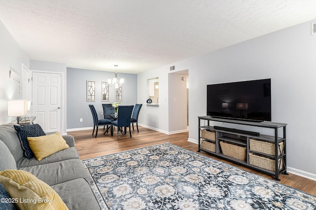 1251 Westlynne Way Apt 2, Louisville, KY 40222 - living area featuring a chandelier, wood finished floors, and a textured ceiling