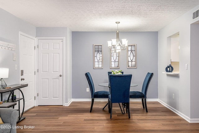 1251 Westlynne Way Apt 2, Louisville, KY 40222 - dining area featuring dark wood-style floors, a chandelier, and a textured ceiling