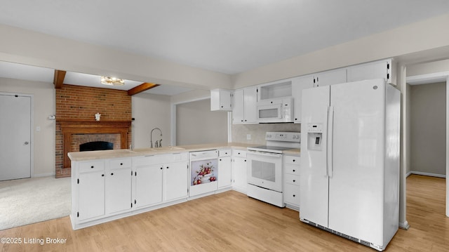 2204 Renown Dr, Jeffersontown, KY 40299 - kitchen with white appliances, a peninsula, light countertops, light wood-style floors, and white cabinetry