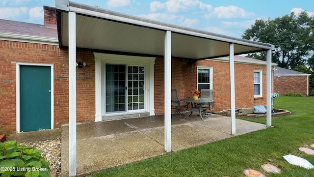 2204 Renown Dr, Jeffersontown, KY 40299 - back of property with a patio, a yard, and brick siding
