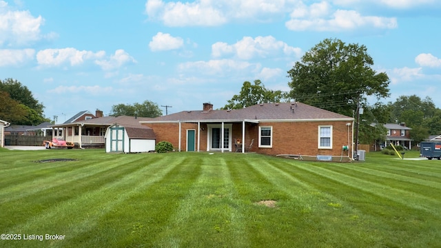 2204 Renown Dr, Jeffersontown, KY 40299 - back of house with a shed, brick siding, and a lawn