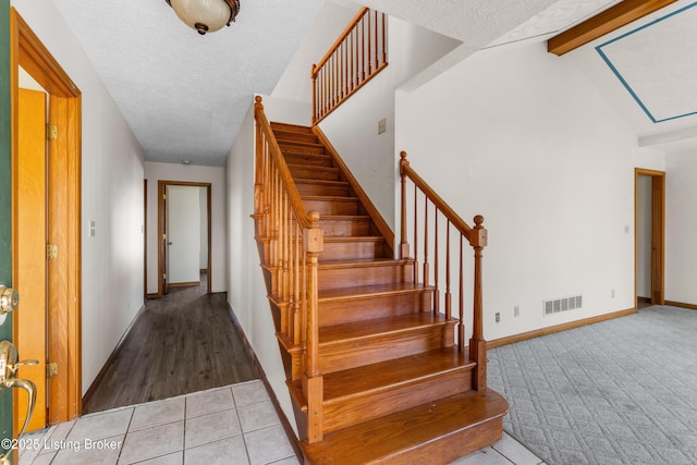 595 Centerview Dr, Shepherdsville, KY 40165 - stairs featuring a textured ceiling, tile patterned floors, and carpet floors