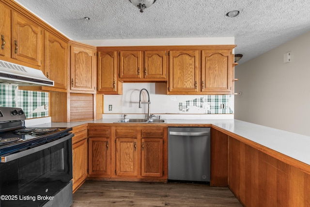 595 Centerview Dr, Shepherdsville, KY 40165 - kitchen with appliances with stainless steel finishes, under cabinet range hood, a textured ceiling, dark wood-type flooring, and brown cabinetry
