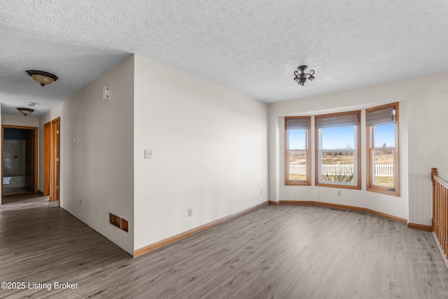 595 Centerview Dr, Shepherdsville, KY 40165 - empty room featuring wood finished floors and a textured ceiling