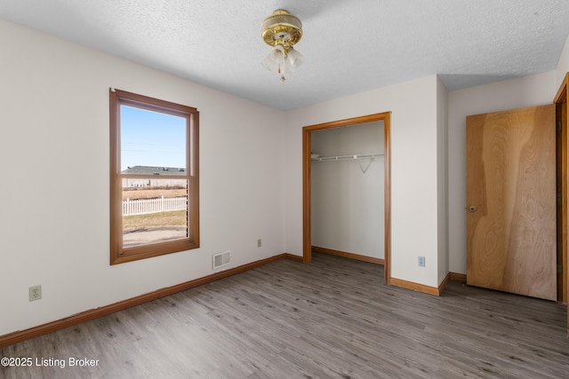 595 Centerview Dr, Shepherdsville, KY 40165 - unfurnished bedroom with wood finished floors, a closet, and a textured ceiling
