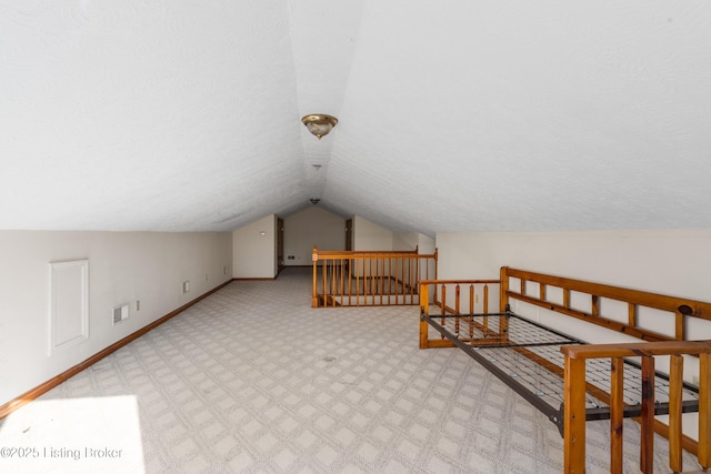 595 Centerview Dr, Shepherdsville, KY 40165 - additional living space featuring vaulted ceiling, carpet flooring, and a textured ceiling