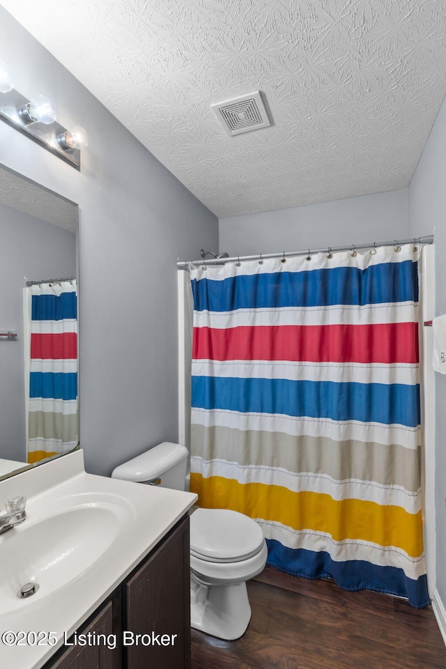 9511 Arrowridge Dr, Louisville, KY 40229 - bathroom with vanity, wood finished floors, a textured ceiling, and a shower with curtain
