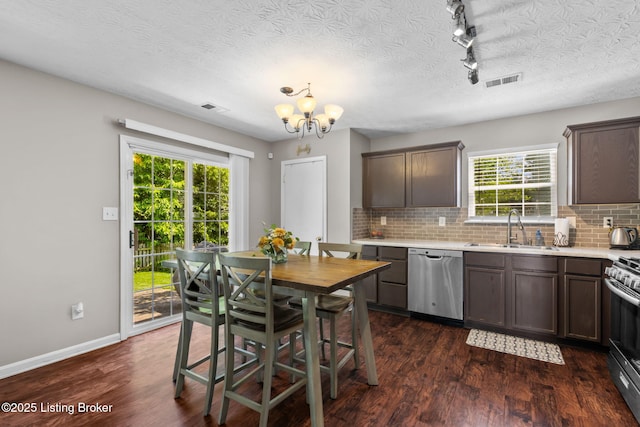 9511 Arrowridge Dr, Louisville, KY 40229 - kitchen with appliances with stainless steel finishes, a chandelier, decorative backsplash, light countertops, and a textured ceiling