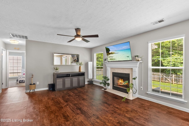 9511 Arrowridge Dr, Louisville, KY 40229 - unfurnished living room with a ceiling fan, wood finished floors, a fireplace, healthy amount of natural light, and a textured ceiling