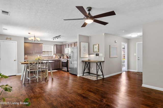 9511 Arrowridge Dr, Louisville, KY 40229 - kitchen with appliances with stainless steel finishes, dark wood-style flooring, a chandelier, light countertops, and a textured ceiling