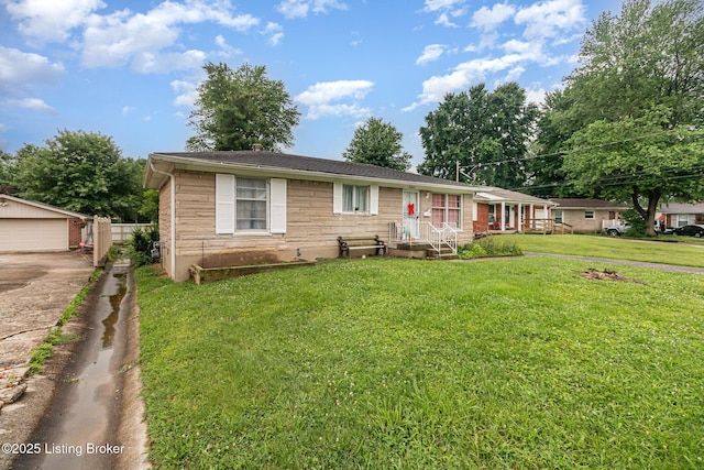 3806 Britt Ln, Louisville, KY 40219 - view of front of house featuring a front yard, an outdoor structure, and a detached garage