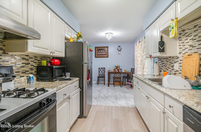 3806 Britt Ln, Louisville, KY 40219 - kitchen with stainless steel appliances, under cabinet range hood, backsplash, and white cabinets