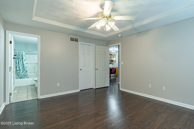 6102 Dalia Ct, Louisville, KY 40272 - unfurnished bedroom featuring ornamental molding, a raised ceiling, dark wood-style flooring, ensuite bathroom, and a ceiling fan