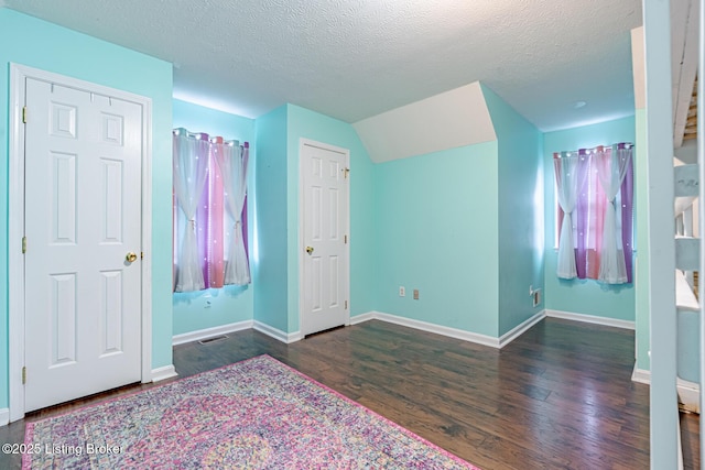 6102 Dalia Ct, Louisville, KY 40272 - unfurnished bedroom featuring wood finished floors, a textured ceiling, and lofted ceiling