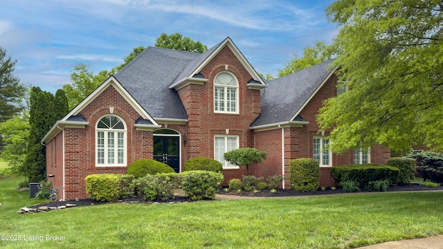 17217 Mallet Hill Dr, Louisville, KY 40245 - view of front of house with brick siding, a front yard, and roof with shingles