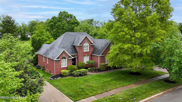 17217 Mallet Hill Dr, Louisville, KY 40245 - view of front facade with brick siding, a front lawn, and roof with shingles