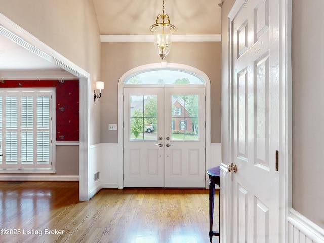 17217 Mallet Hill Dr, Louisville, KY 40245 - foyer entrance featuring a wainscoted wall, wood finished floors, ornamental molding, and french doors