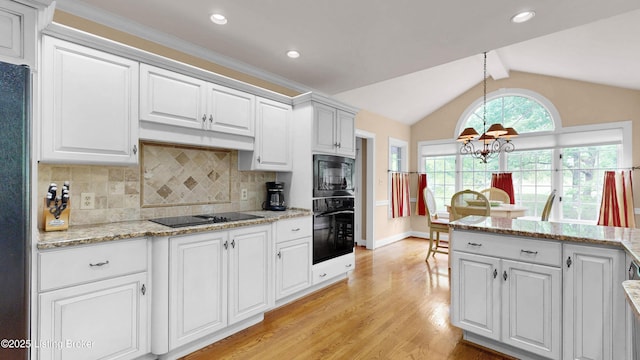 17217 Mallet Hill Dr, Louisville, KY 40245 - kitchen featuring black appliances, light wood finished floors, a chandelier, vaulted ceiling, and decorative backsplash