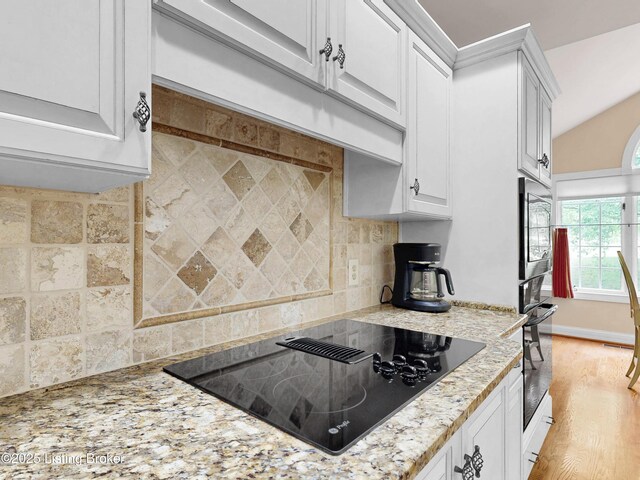 17217 Mallet Hill Dr, Louisville, KY 40245 - kitchen featuring black appliances, white cabinets, backsplash, and light stone countertops