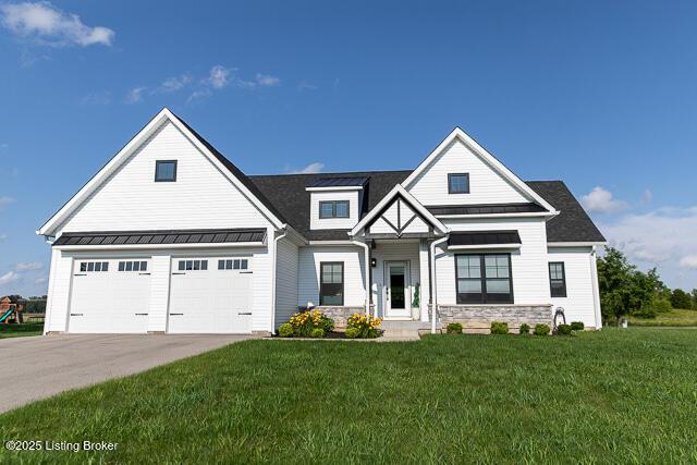2370 N Borcherding Rd, Madison, IN 47250 - view of front of property with driveway, a front yard, a garage, stone siding, and a standing seam roof