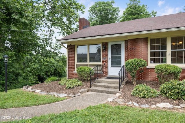 1669 Trigg St, Louisville, KY 40213 - view of front facade featuring a chimney and brick siding