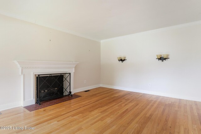 1669 Trigg St, Louisville, KY 40213 - unfurnished living room with light wood-style floors, crown molding, and a fireplace with flush hearth