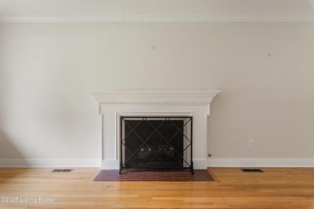 1669 Trigg St, Louisville, KY 40213 - detailed view of wood finished floors, a fireplace with flush hearth, and crown molding