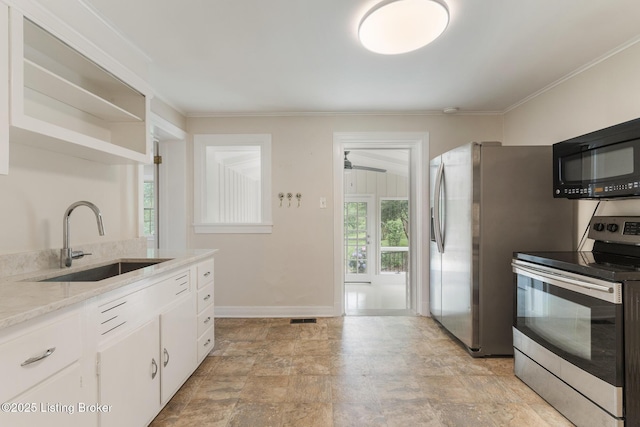 1669 Trigg St, Louisville, KY 40213 - kitchen featuring electric range, black microwave, white cabinets, crown molding, and light stone counters