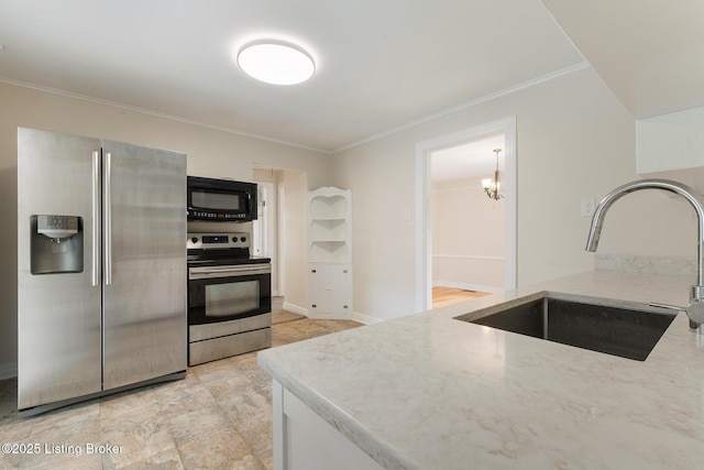 1669 Trigg St, Louisville, KY 40213 - kitchen featuring appliances with stainless steel finishes, light stone counters, crown molding, and a chandelier