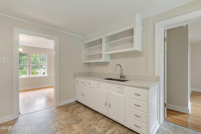 1669 Trigg St, Louisville, KY 40213 - kitchen with open shelves, light countertops, white cabinetry, and crown molding
