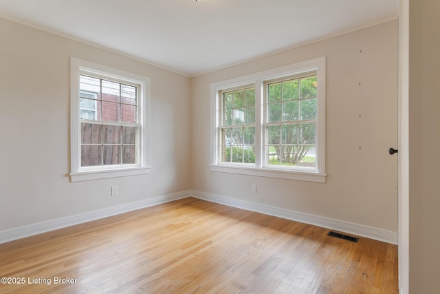 1669 Trigg St, Louisville, KY 40213 - spare room featuring plenty of natural light, light wood finished floors, and ornamental molding