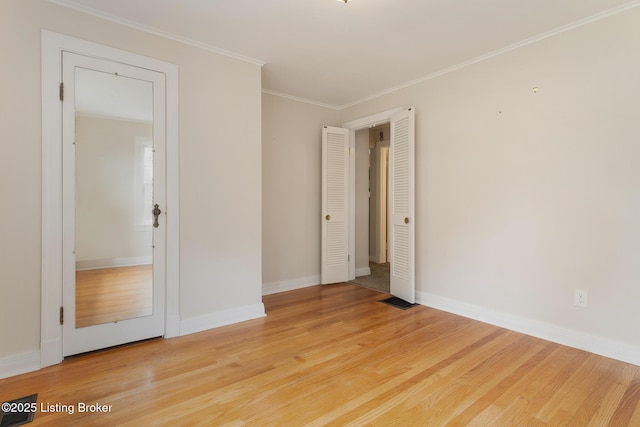 1669 Trigg St, Louisville, KY 40213 - spare room with light wood-style flooring and ornamental molding