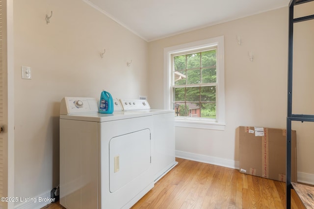 1669 Trigg St, Louisville, KY 40213 - washroom with independent washer and dryer, light wood finished floors, and crown molding
