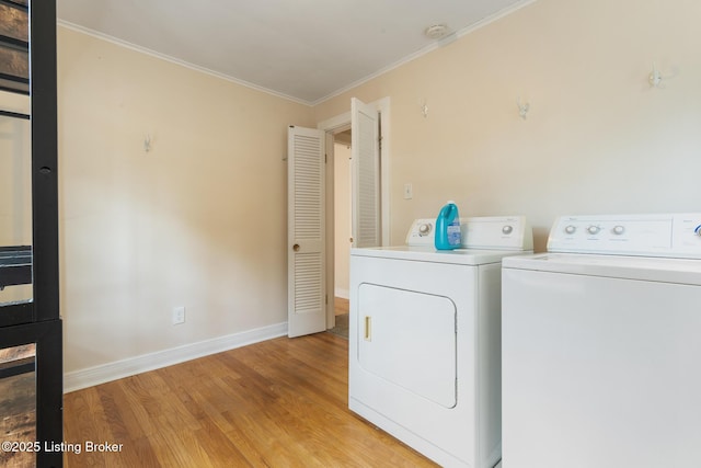 1669 Trigg St, Louisville, KY 40213 - washroom with separate washer and dryer, light wood-style flooring, and ornamental molding