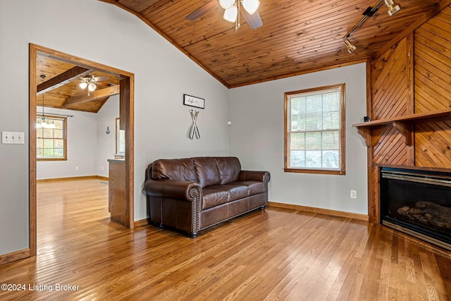 2773 Martin Pierce Rd, Cub Run, KY 42729 - living room featuring lofted ceiling, ceiling fan, wood ceiling, light wood-style floors, and a glass covered fireplace