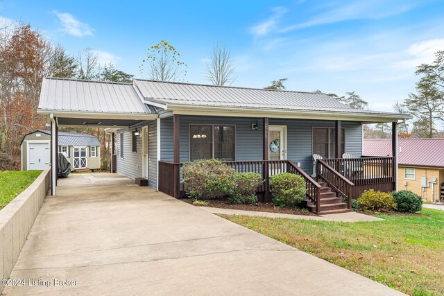 2773 Martin Pierce Rd, Cub Run, KY 42729 - view of front of property with driveway, a porch, an attached carport, a shed, and a metal roof
