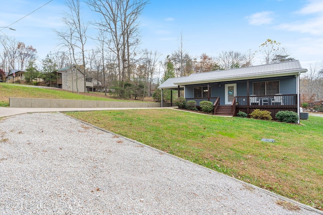 2773 Martin Pierce Rd, Cub Run, KY 42729 - ranch-style house featuring gravel driveway, covered porch, a front lawn, and a metal roof