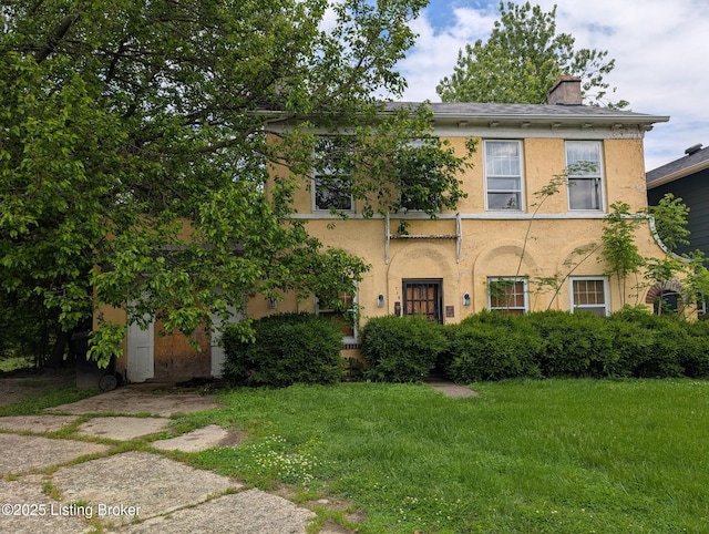 716 Cedar Grove Ct, Louisville, KY 40212 - view of front of property featuring stucco siding, a chimney, and a front yard