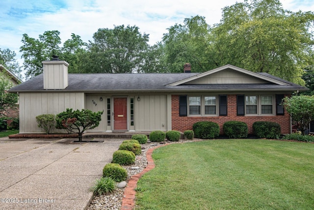 107 Westwood Dr, Elizabethtown, KY 42701 - view of front of property with a chimney, a front lawn, roof with shingles, and brick siding