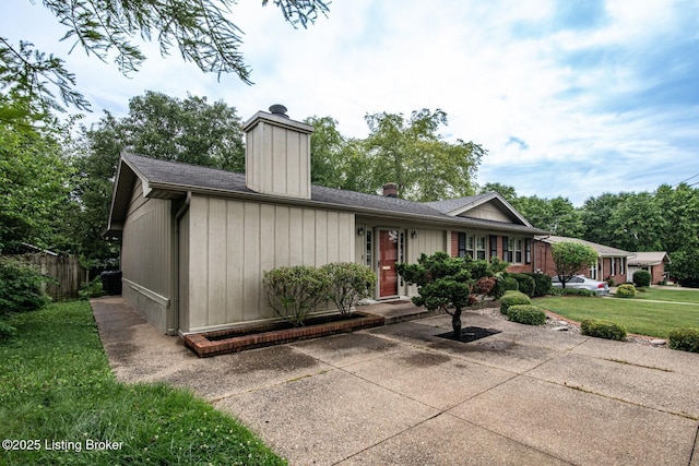 107 Westwood Dr, Elizabethtown, KY 42701 - single story home with a chimney, a patio area, and a shingled roof
