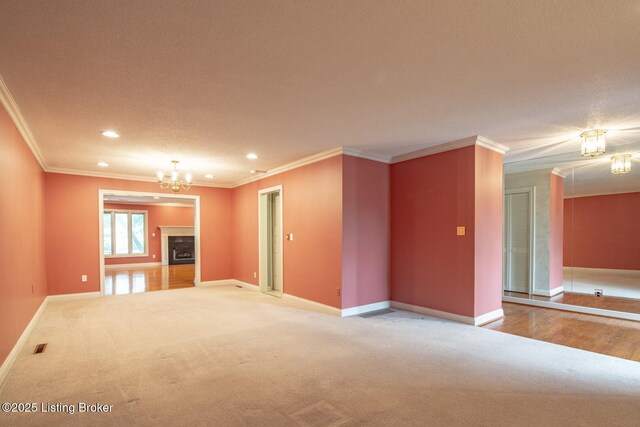 107 Westwood Dr, Elizabethtown, KY 42701 - unfurnished living room featuring crown molding, light colored carpet, recessed lighting, and a chandelier