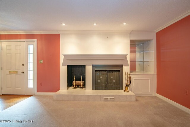 107 Westwood Dr, Elizabethtown, KY 42701 - unfurnished living room with carpet floors, a glass covered fireplace, ornamental molding, built in shelves, and recessed lighting