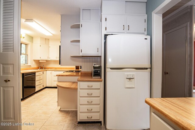 107 Westwood Dr, Elizabethtown, KY 42701 - kitchen with white refrigerator with ice dispenser, black dishwasher, open shelves, white cabinetry, and light tile patterned floors