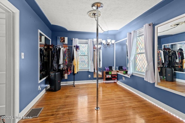 1120 Dresden Ave, Louisville, KY 40215 - workout area with a chandelier, wood finished floors, and a textured ceiling