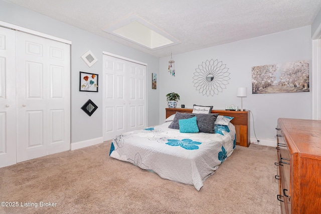 4906 Roman Dr, Louisville, KY 40291 - carpeted bedroom with baseboards and two closets