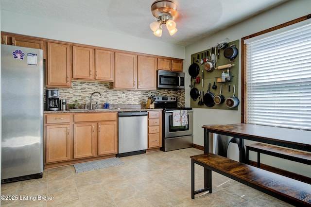 4606 Haeringdon Dr, Jeffersontown, KY 40299 - kitchen featuring appliances with stainless steel finishes, ceiling fan, decorative backsplash, light stone countertops, and brown cabinets