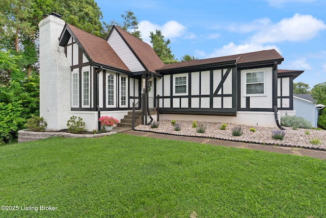 7813 Delightful Way, Louisville, KY 40291 - tudor house with a chimney, a front lawn, a shingled roof, and brick siding