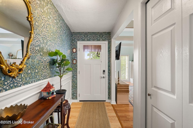 7813 Delightful Way, Louisville, KY 40291 - entryway with wallpapered walls, wood finished floors, and a textured ceiling