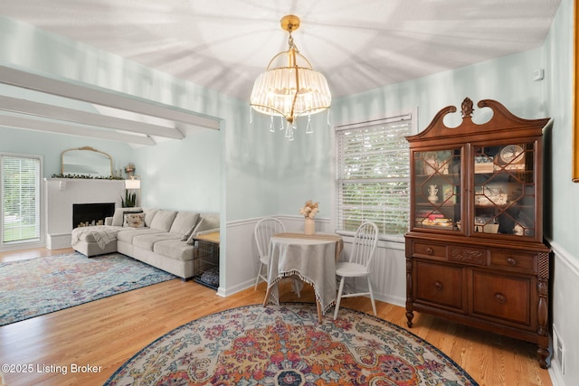 7813 Delightful Way, Louisville, KY 40291 - living area with a chandelier, wood finished floors, and a fireplace with raised hearth